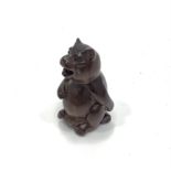 A Japanese Meji period hand carved boxwood netsuke of a bear scratching its bottom, with Himotoshi