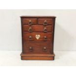 A Victorian mahogany miniature chest of drawers, with two short above three longer graduated