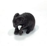 A Japanese Meji period hand carved boxwood netsuke of a goat eating a leaf, signed to base with