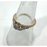 An 18ct gold solitaire diamond ring, with a small diamond in a claw setting, estimated weight of