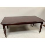 A large reproduction mahogany dining table with additional leaf, raised on turned tapering reeded