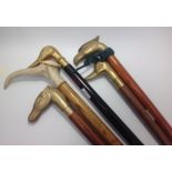 Five various walking sticks including four with brass handles comprising 2 x ducks, 1 x eagle and