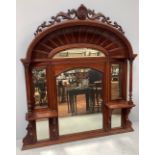 A large 20th century walnut ornate over-mantle mirror with curved arched pierced and scrolled