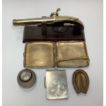 A silver gilt cigarette case, together with a silver backed notebook holder, silver rimmed glass