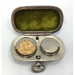 A 22ct gold George V 1912 Sovereign weighing 8.0 grams, in white metal double coin holding case.