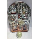 A dome shaped shelved leaded glass display cabinet containing a selection of glass ornaments