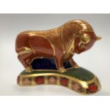 A Royal Crown Derby paperweight, 'Harrods Bull', with printed marks to base and gold stopper,
