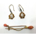 A yellow gold and coral brooch, sceptre style end with chain loop suspending a coral droplet,