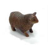 A Japanese Meji period hand carved boxwood netsuke of a sheep, signed to base with Himotoshi cord