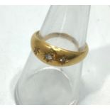 An 18ct yellow gold star set diamond dress ring, set with three small round brilliant cut