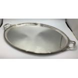 A large silver salver by Thomas Bradbury & Sons Ltd, of oval form and with reeded edge and