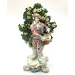 A Chelsea Gold Anchor figure of a drummer boy, modelled on a rococo base against floral bocage, '