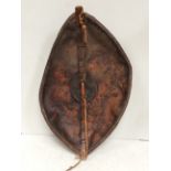 A 19th century Maasai shield, Kenya hide with painted geometric decoration in earth red and black (