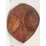 A Maasai shield Kenya hide with painted with red, white, blue, black and yellow geometric