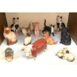 A collection of 11 various ceramic, composite and stone model cats including some Royal Doulton