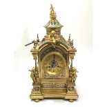 A 19th Century French ormolu mantle clock, modelled as a pagoda, surmounted by three cherubs, the