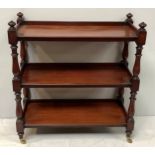 A Victorian mahogany three tier buffet / serving table with turned finials, raised on baluster