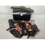 A quantity of leather hand-gun holsters and magazine pouches, together with a leather Gladstone-