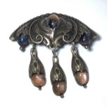 A Danish silver art nouveau brooch with arched beaded top, central moonstone in a floral setting,