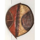 A late 19th / early 20th century Maasai shield, Kenya hide with painted geometric decoration in red,