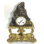 A figural gilt spelter mantel clock, the circular white enamel dial with Roman numerals denoting