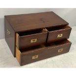 A campaign style low chest of two short over two short drawers with brass flush handles and flush