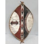 A Mid 20th century Maasai shield, Kenya hide with painted geometric decoration in earth red, black