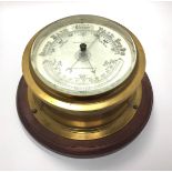 A brass cased ship's bulkhead barometer with white enamel dial marked 'Whyte Thomson & Co, Glasgow &