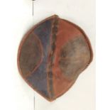 An early to mid-20th century Maasai shield, Kenya hide with painted geometric decoration in earth