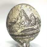 A Scrimshaw Ostrich Egg profusely worked with a continuous whaling and maritime scene, 13cm high