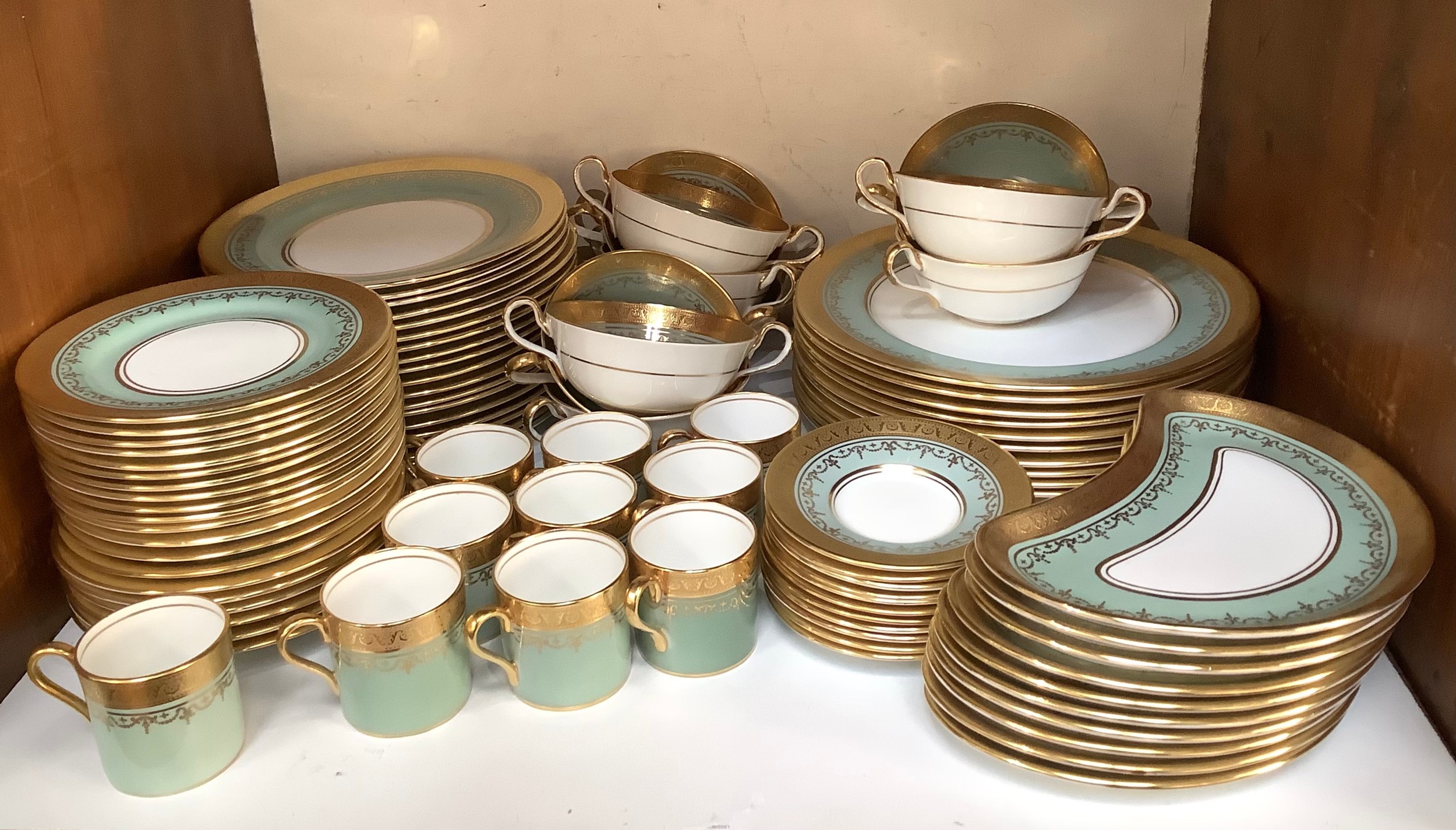 An Aynsley part dinner and coffee service, decorated in a green, white and gilded design and