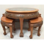 An Oriental carved hardwood coffee table, of circular form, the top profusely carved with scenes