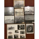 A collection of assorted framed and unframed monochrome photographs depicting various battleships