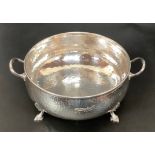 A silver-plated Arts and Crafts, twin-handled, planished bowl by Mappin and Webb, raised on four