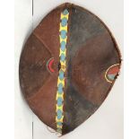 An early 20th century large Maasai shield, Kenya hide with painted geometric decoration in earth