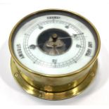 A circular brass ship's bulkhead aneroid barometer, 19cm diameter