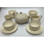 Eleven Belleek porcelain tea wares comprising four cups and saucers, a teapot, a milk jug and a