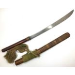 A Burmese Dha sword with wooden, copper and rattan plaited handle, curved steel blade widening at