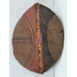 An early to mid 20th century Maasai shield, Kenya hide painted with red, white, black and yellow