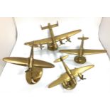 Four brass desk model aeroplanes raised on stands to brass bases including an Avro Lancaster