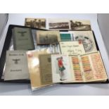 A collection of Nazi ephemera including 2x work passes, and worker's book with stamps, small