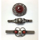 Three various silver brooches including a Danish bar brooch set with two cornelian coloured stones