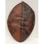 An early 20th century Maasai shield, Kenya hide with painted in red and black geometric