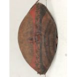 A good late 19th/ early 20th century Maasai shield, Kenya, hide with painted red and black geometric