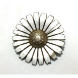 A Danish Georg Jensen silver daisy brooch / pendant, with white enamelled petals and silver-gilt