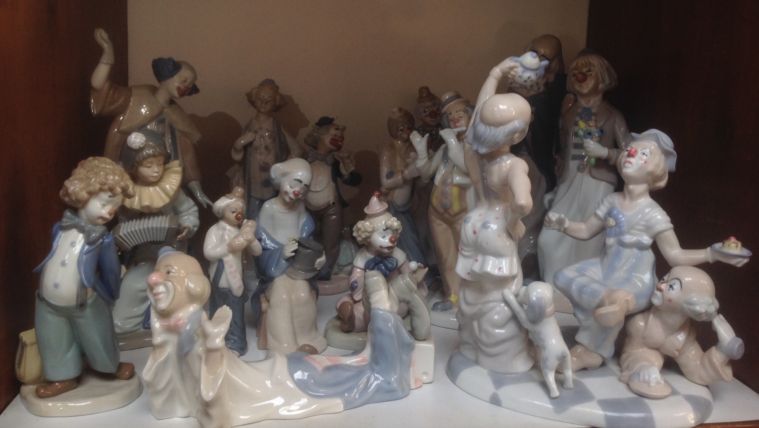 A 'Shudder' of Spanish porcelain clowns / pierrot including a large Casades figure group of three