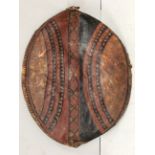 An early to mid 20th century Maasai shield, Kenya hide with painted in earth red and black geometric