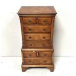 A Bevan & Funnell Reprodux mahogany glove chest comprising eight drawers of varying sizes, raised on