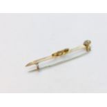 A yellow metal bar brooch, set with seed pearls and an old cut diamond to the centre of the moon and