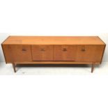 A Nathan teak sideboard, with bank of three fitted cutlery drawers, fall front drinks cupboard and